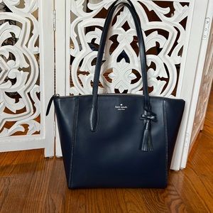 Navy Kate Spade tote in like new condition with care booklet.